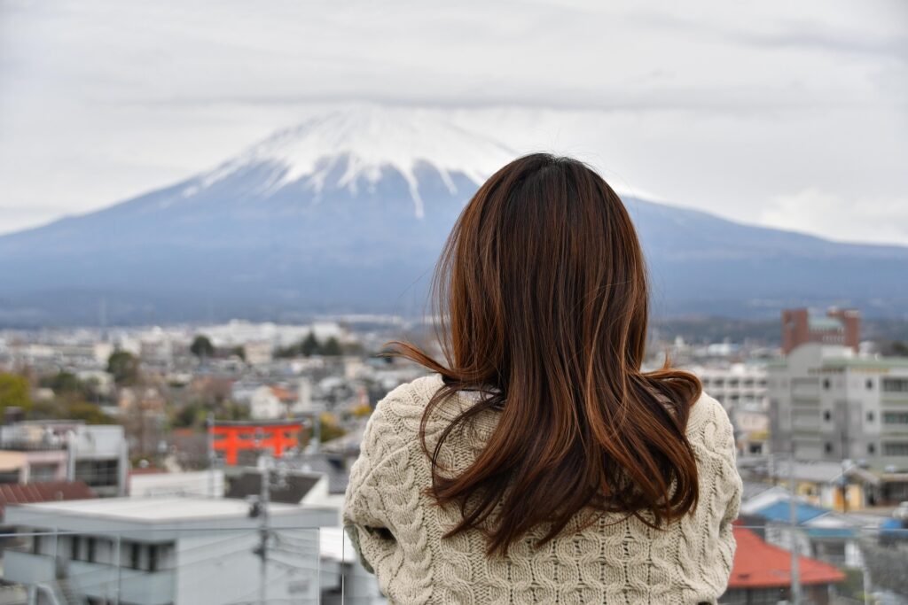 a girl sitting alone and thinking about something from a rooftop.
